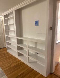 Custom white built-in shelving installation and finish carpentry in Massachusetts