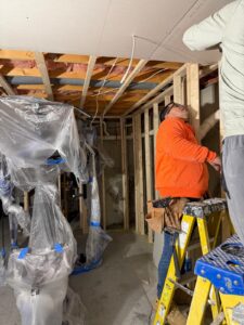 Drywall ceiling installation during basement remodeling project in Massachusetts