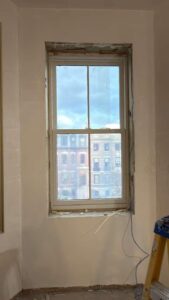 Window opening preparation before trim installation during renovation in Massachusetts