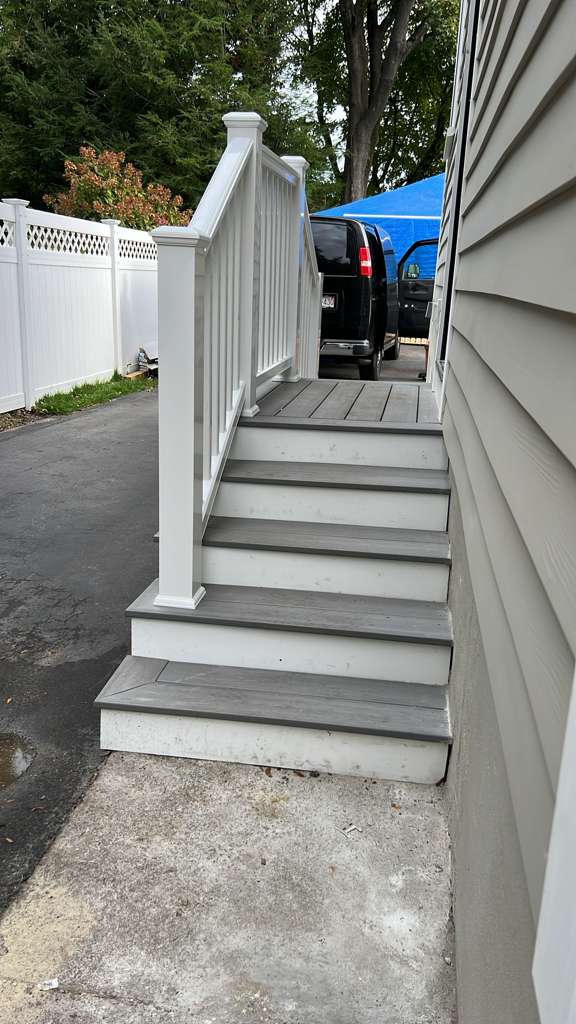 Finished side entry stairs with gray composite treads and white railing