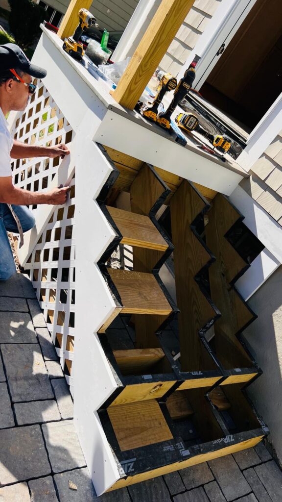 Boldwood Finishes carpenter installing lattice on new exterior stairs