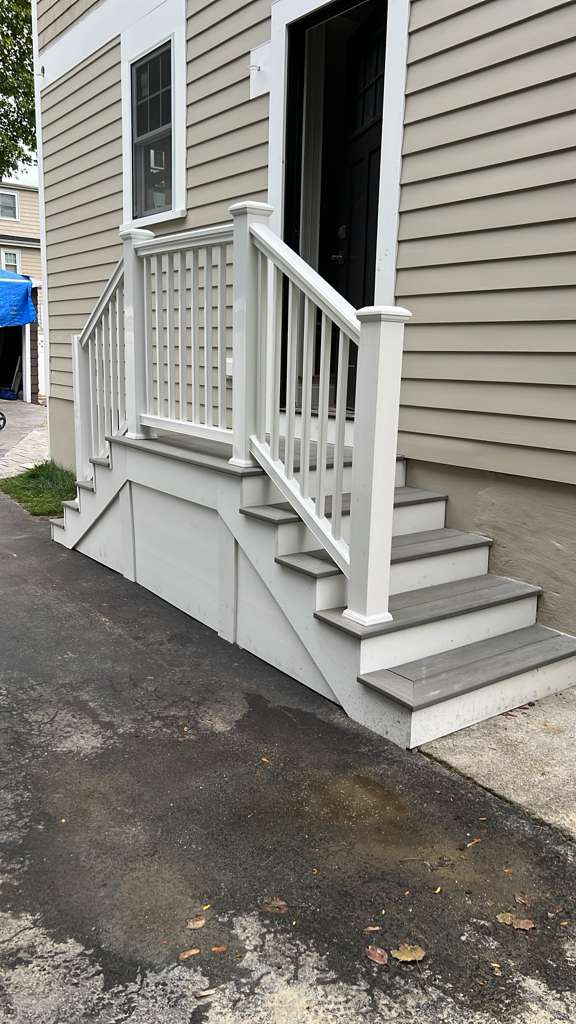 Finished exterior stairs with skirt boards and white railing